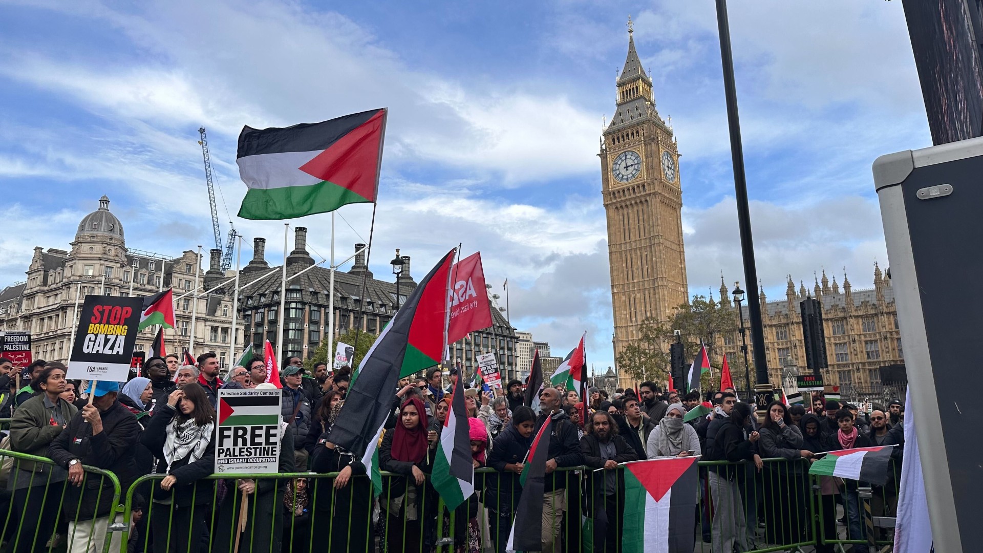 Protesters hold placards and wave Palestinian flags as they walk through central London during a 'March For Palestine', on 28 October 2023.
