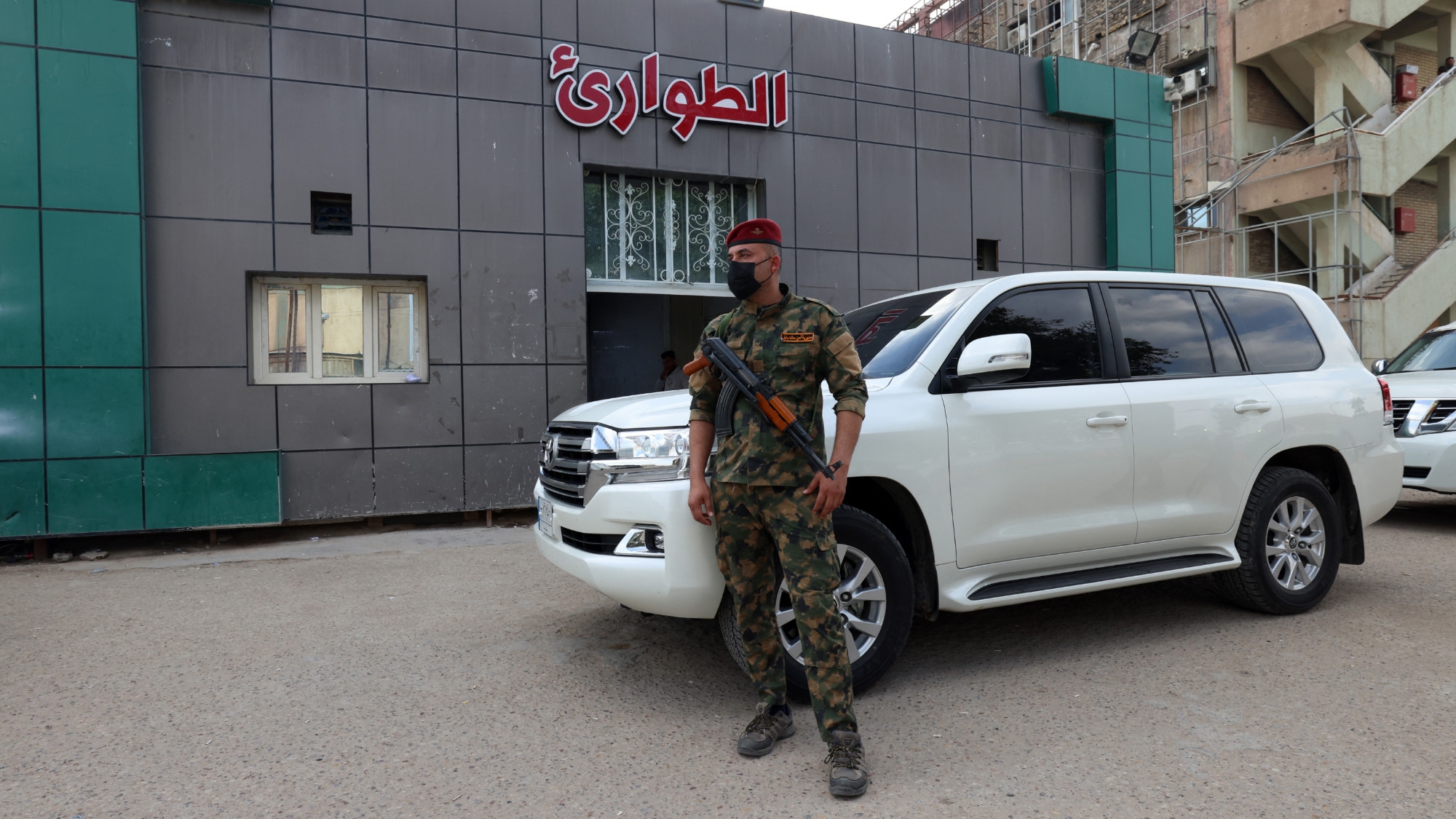 A soldier stands guard outside a hospital in Hilla in the Babylon province where people wounded in a bombing overnight on a military base housing a coalition of pro-Iranian armed groups are being treated, on 20 April 2024 (AFP)
